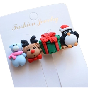 Detailed view of Christmas hair clips featuring resin bear, reindeer, and penguin charms