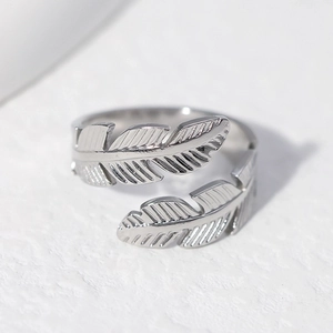 Adjustable silver feather ring in stainless steel with detailed plume texture on white base