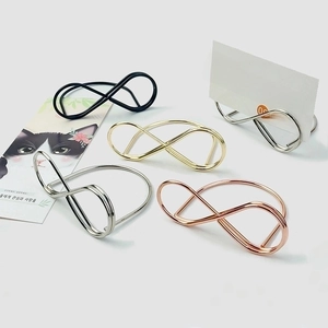 Infinity shape metal place card holders in gold, silver, black, and rose gold finish