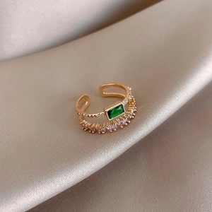 Minimalist double-layer gold-plated open ring with green rectangle zircon on silk background
