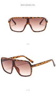 Front and 45-degree side view of oversized demi-frame sunglasses with tea gradient lenses