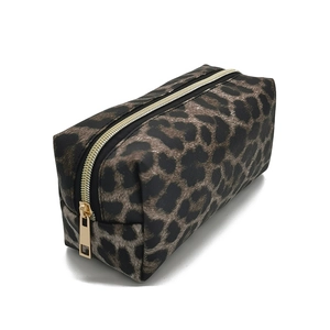 Detail view of the durable leopard print fabric texture and zipper on the makeup bag