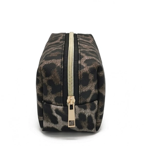 Detail view of large leopard print makeup bag featuring a textured finish and gold zipper