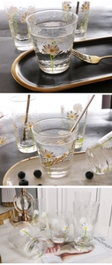 Macro shot of hammer-textured glass cup featuring delicate hand-painted daisy prints