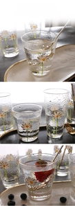 Detailed view of hammered glass texture and daisy print on tall and short juice cups