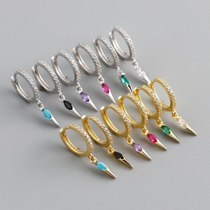 Detail of colorful gemstone cone pendants on silver and gold s925 hoop earrings