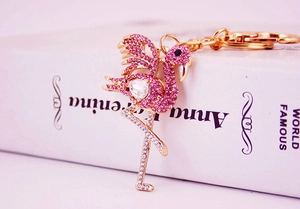 Macro detail of rose gold flamingo keychain with sparkling pink and white rhinestones