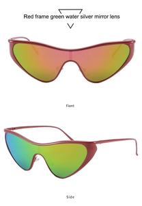 Macro view of futuristic red triangle sunglasses with iridescent green mirrored lenses