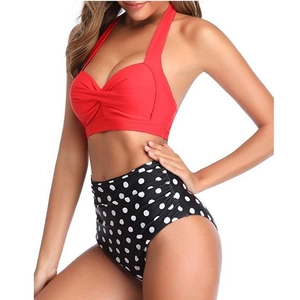 Detail of red halter neck bikini top with twist knot and high waist polka dot bottom