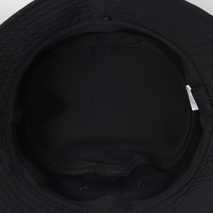 Detailed macro view of the inner stitching and polyester fabric on a black bucket hat