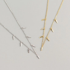 Detailed view of silver and gold spiked evil eye necklaces with cubic zirconia accents