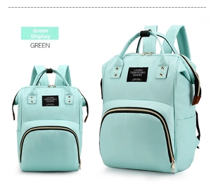 Detail of mint green oxford fabric diaper bag featuring wide opening and waterproof surface