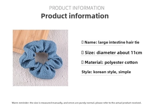 Detail of blue seersucker scrunchie showing pleated texture and 11cm diameter size