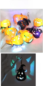 Detail of LED Halloween pumpkin lantern with colorful light projection and hanging rope