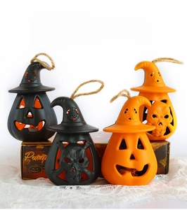 Detail of Halloween LED lanterns with pumpkin, skull, and witch hat motifs with hemp rope