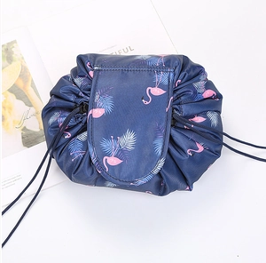 Lazy drawstring cosmetic makeup bag with flamingo tropical leaf print detail for travel storage.