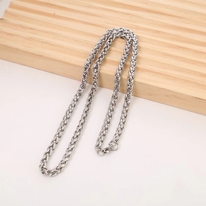 Polished silver stainless steel dragon bone chain necklace with spring clasp on wood