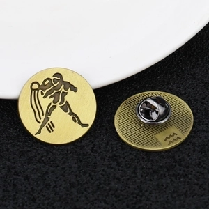 Golden Aquarius zodiac pins in brushed metal finish with secure rubber backings