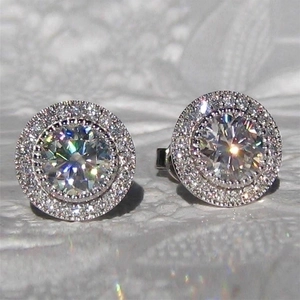 Macro view of sterling silver halo stud earrings with round brilliant cubic zirconia stones