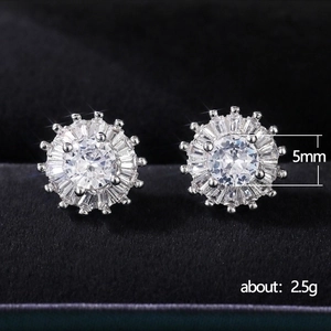 Elegant 5mm zircon halo flower stud earrings in white gold plating on black velvet