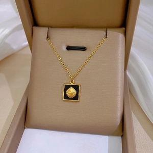 Minimalist gold titanium necklace featuring a square black pendant with a 3D shell design