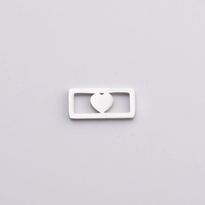 Polished silver stainless steel rectangular pendant with hollow heart cutout on white background