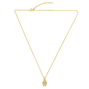 Detail of gold necklace featuring a diamond-encrusted girl pendant and lobster clasp