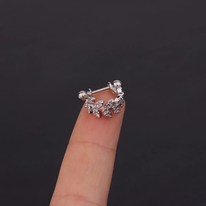 Silver U-shaped leaf cartilage earring with micro-pave cubic zirconia on a fingertip