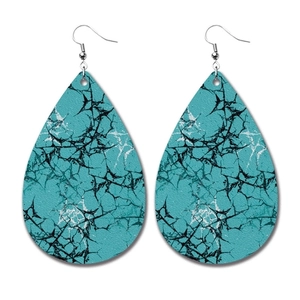 Detailed view of teardrop PU leather earrings with blue and black crackle pattern