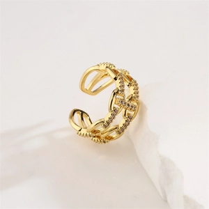 Detail of gold zircon star ring featuring double-layer hollow chain design on white stone