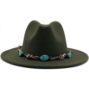 Close-up of dark green fedora with bohemian braided band and turquoise stone detail