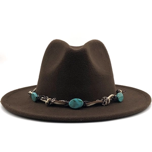 Close-up of brown wool fedora hat featuring bohemian turquoise beads and braided trim