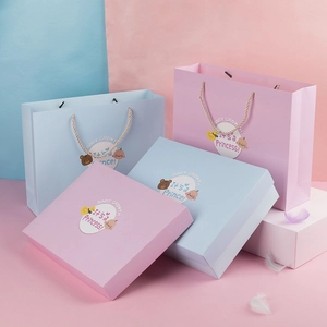 Pink and blue newborn baby gift box sets with gold handles and bear illustrations