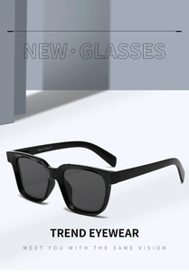 Detail shot of black square sunglasses with sturdy hinges and UV400 dark grey lenses