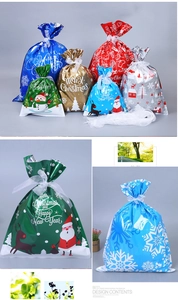 Detail of colorful Christmas drawstring candy bags with Merry Christmas holiday printing