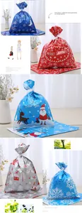 Detail of glossy Christmas drawstring gift bags with Santa and reindeer motifs