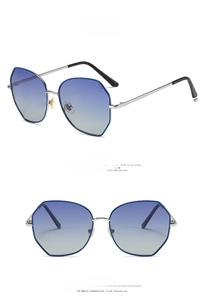 Close-up of polygon metal sunglasses with blue-silver frame and gradient blue lenses