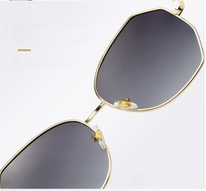 Detailed close-up of soft silicone nose pads on gold round metal sunglasses frame