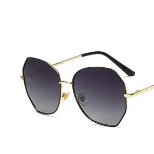 Women's gold metal round sunglasses with grey gradient lenses and UV protection