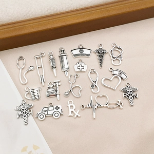 Detailed collection of silver medical charms including stethoscopes and nurse hats