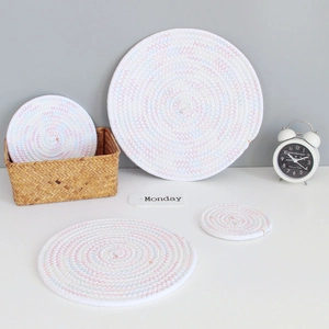Detail of round woven cotton coasters set with colorful stitching and spiral patterns