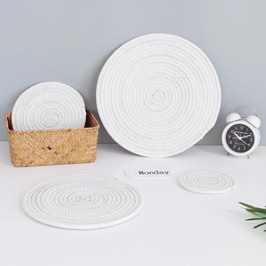 Close-up of assorted white woven cotton coasters in various sizes for table protection