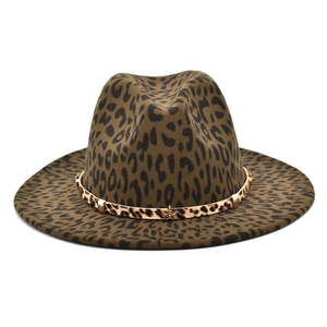 Detailed close-up of leopard print wool fedora hat with gold star metal accent
