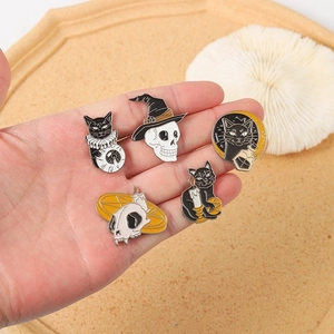 Five-piece Halloween gothic enamel pin set featuring black cats and skulls on a hand palm