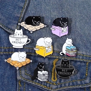 Set of 8 cute enamel cat brooches pinned on denim jacket pocket for stylish decoration