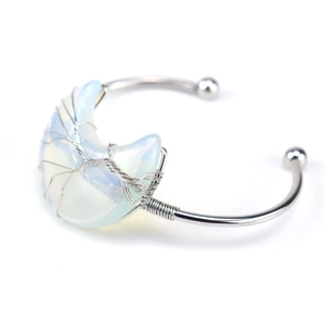 Detail of silver wire-wrapped tree of life bangle with opal crescent moon charm