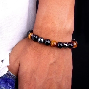 Men's beaded bracelet with natural tiger eye, obsidian, and hematite stones on wrist