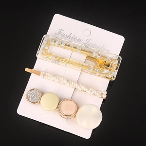 Detailed view of 3-piece hair clip set with resin, faux pearls, and colorful round motifs