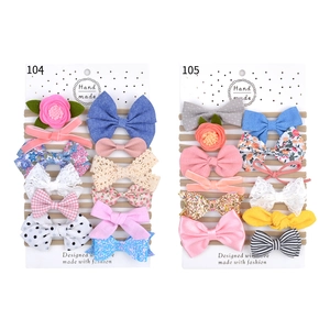 Detail view of 10-piece elastic bow headbands set with various lace and fabric textures