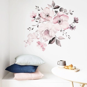 Macro detail of watercolor pink floral wall stickers in a cozy home bedroom setting